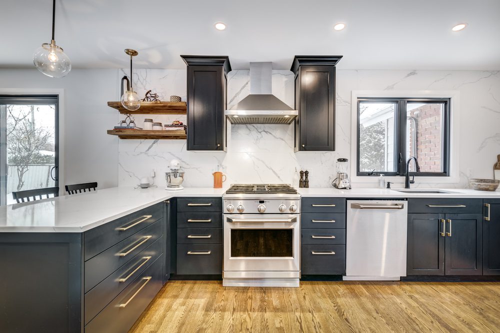 New appliances in modern kitchen with black and white color scheme and wood flooring